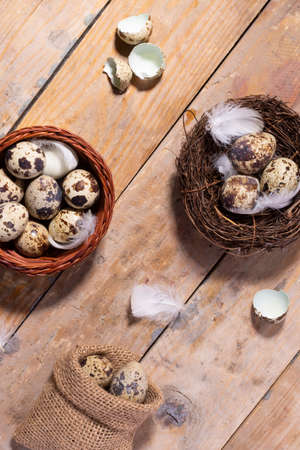 Quail eggs and feathers in the burlap sack, nest, top view, zero waste concept