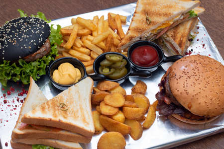 Closeup of home made two sesame burgers on wooden background, top viewの写真素材