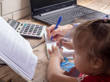 girl writing with pen homework, booksのeditorial素材