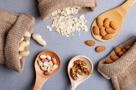 Walnuts, hazelnuts and almonds in eco bags, sackclothes. Zero waste concept. Top view