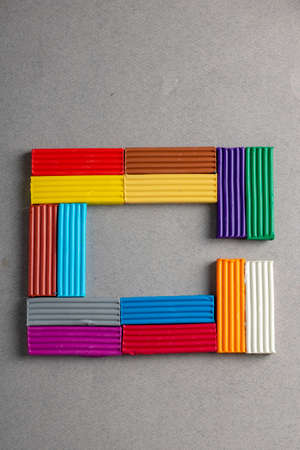 Plasticine frame, multicolored clay on gray paper. Vertical image, nobody. View aboveの写真素材