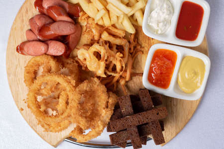 Crispy bread for beer snacks. Flat lay, sauces and grilled sausages.の写真素材