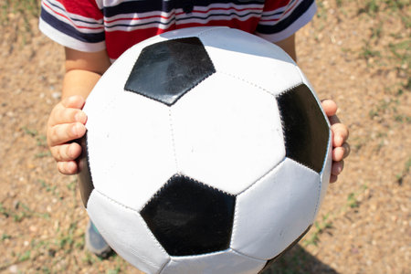 foot ball player holding the ball in one hand