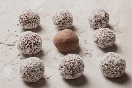 Chocolate and vegan balls on gray table