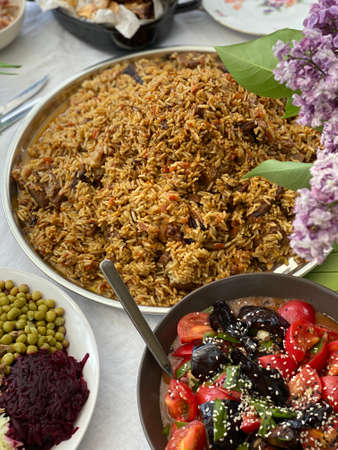 Pilaf with vegetables and lilac flowers, verticalの写真素材