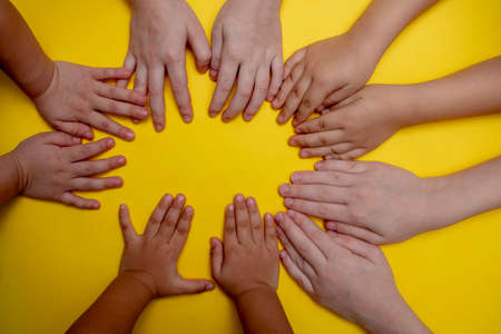 Happy mix family concept, hands of sister and brothersの写真素材