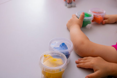Little girls creating toys from play dough, place for textの写真素材