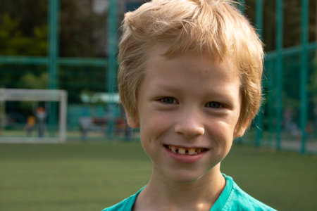 Preschooler happy on football field, smile and laugh