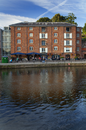 EXETER, UK, 12 July 2016: four storey building and outdoor cafes on the Exeter Quay. Devon.のeditorial素材