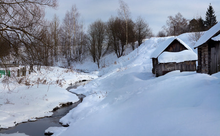nonfreezing a small river. Bath House on the bank. Frosty. Vyatskoe village. Yaroslavl region. Russiaの写真素材