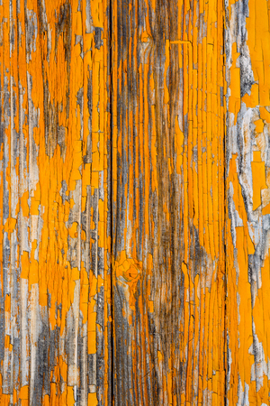 Wooden boards covered with peeling orange paint. Rough texture. Backgroundの写真素材