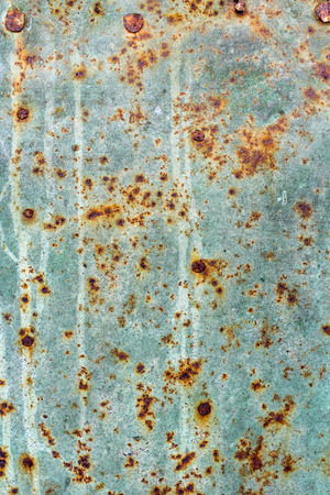 The surface of old steel sheet. Painted blue paint. Several nails.