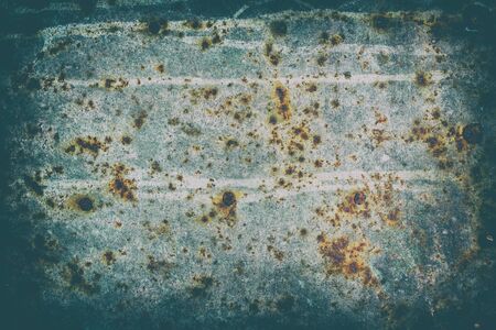 The surface of old steel sheet corrosion-damaged. Blue color. Stylized with a vignette effect.の写真素材