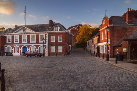 Customs House in Exeter. Evening light. Nobody. The car on the paved area.