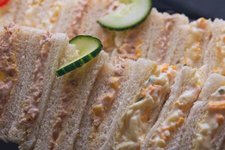 many sandwiches with sauce, cheese and cucumberの写真素材