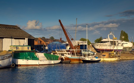Boats are in the harbor with a crane. Exeter. Devon. Englandの写真素材