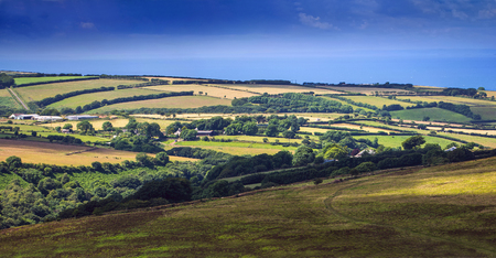 hills and pastures in Exmoor. On the horizon is seen sea. North Devon. UKの写真素材