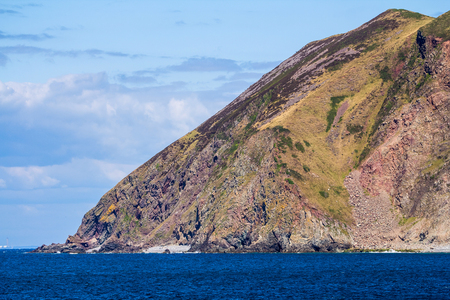 North Devon Coast near the villages of Lynton and Lynmouth. Rocks are adjacent into a dense to the sea. Sunny day and blue sky. UKの写真素材