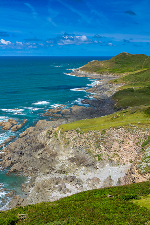 The sea and the rocky shore in northern Devon. Near the village and beach of Woolacombe. It is seen in the distant Mortehoe Point. Englandの写真素材