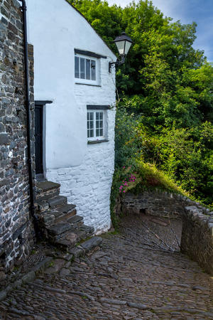 A small street in the coastal village of Clovelly. A cobbled path, a white house with a lantern. Devon. Englandの写真素材