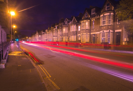 Evening Exeter. Street with night lights. You can see tracers from cars passing by. Devon. Englandの写真素材