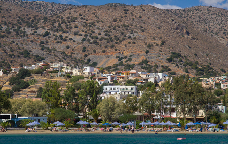 Elounda, Crete, Greece, 22 September 2013: Beach with holidaymakers people near the village of Elounda. The Bay of Mirabelloのeditorial素材
