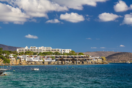 A large hotel by the sea. A boat is visible. Good weather. Day. Gulf of Mirabelo. Crete. Greeceの写真素材