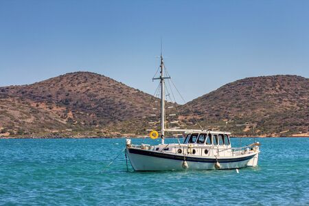 A moored small boat in the Gulf of Mirabello, near the village of Elounda. Crete. Greeceの写真素材