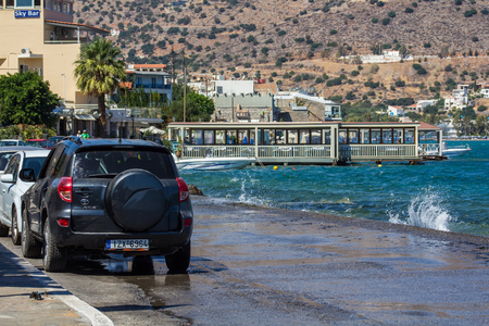 Elounda, Crete, Greece, 22 September 2013:  Cars are parked on a narrow path along the water's edge of the Mirabello Bay.のeditorial素材