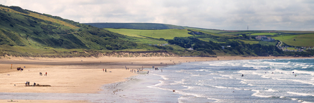 Panoramic view of the beach of Woolacombe. Waves on the sea and people on the shore.の写真素材