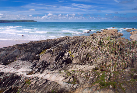 Coastal rocks visible at low tide. Beautiful coast in Woolacombe. Devon. Englandの写真素材