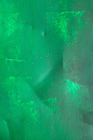 Metal surface. Painted unevenly green. Visible dents. Natural backgroundの写真素材