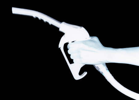 XRAY IMAGE OF HAND HOLDING PETROL PUMP ISOLATED ON BLACK BACKGROUNDの写真素材