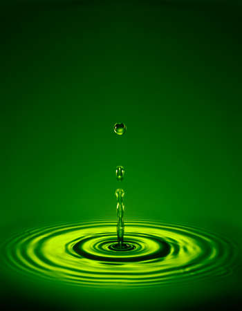 Droplet with ripple in liquid.の写真素材