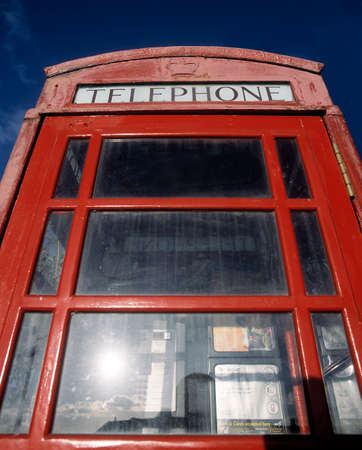 TRADITIONAL ENGLISH TELEPHONE BOX AGAINST BLUE SKY