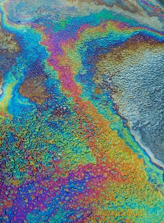 MULTI COLOURED PATTERNS OF OIL FLOATING ON WATERの写真素材
