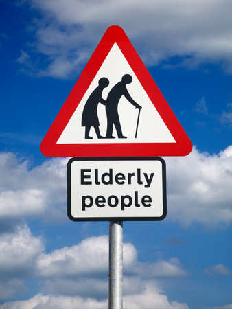 ELDERLY PEOPLE ROAD TRAFFIC SIGN AGAINST BLUE SKYの写真素材