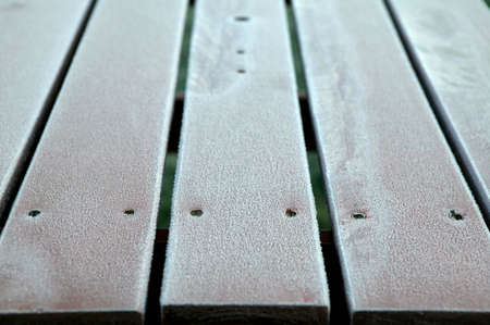 EARLY MORNING FROST ON WOODEN BENCHの写真素材
