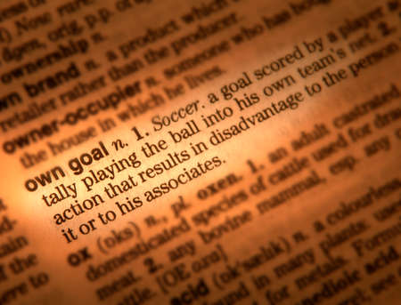 Close up of dictionary page showing definition of the word own goalの写真素材