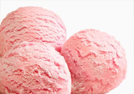 Three scoops of strawberry ice cream isolated on white backgroundの写真素材