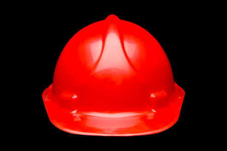 Red hard hat safety helmet isolated on black backgroundの写真素材