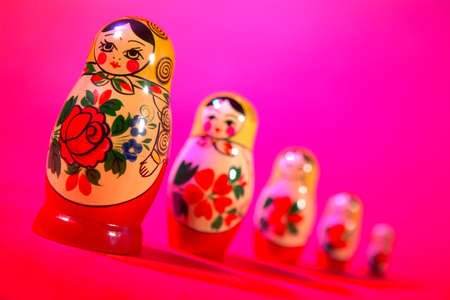 Russian dolls on pink red backgroundの写真素材