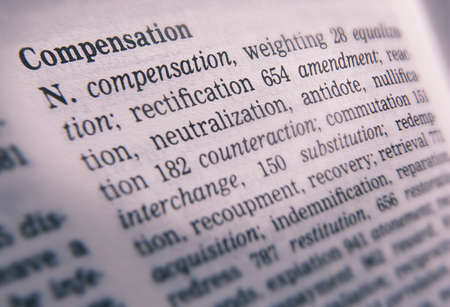 Close up of thesaurus page showing description of the word Compensationの写真素材