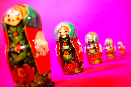 Russian dolls in a line on pink backgroundの写真素材