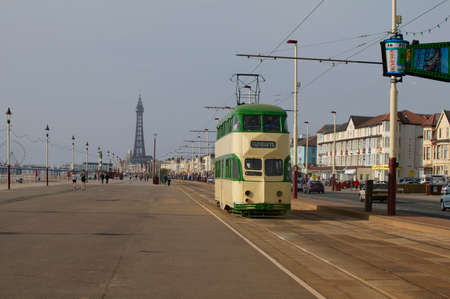 Tram on Golden Mile with Blackpool Tower and north pier in background, Englandのeditorial素材