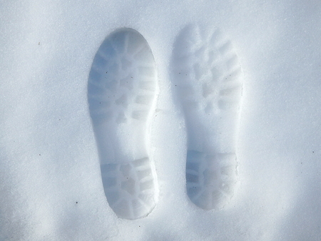 Human footprint in white snow,