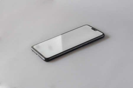 mobile phone with white screen on gray background