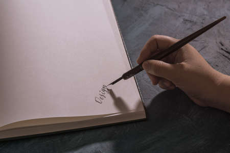 traditional handwritten calligraphy, on an old book.