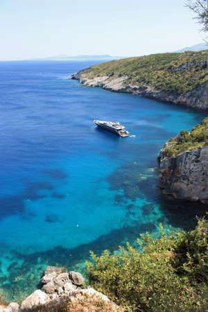 Boat in bay at Kefalonia (vertical)の写真素材