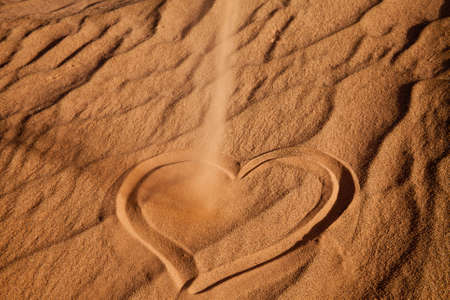 heart shape on sandの写真素材